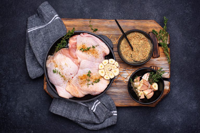 Raw uncooked chicken thighs with garlic